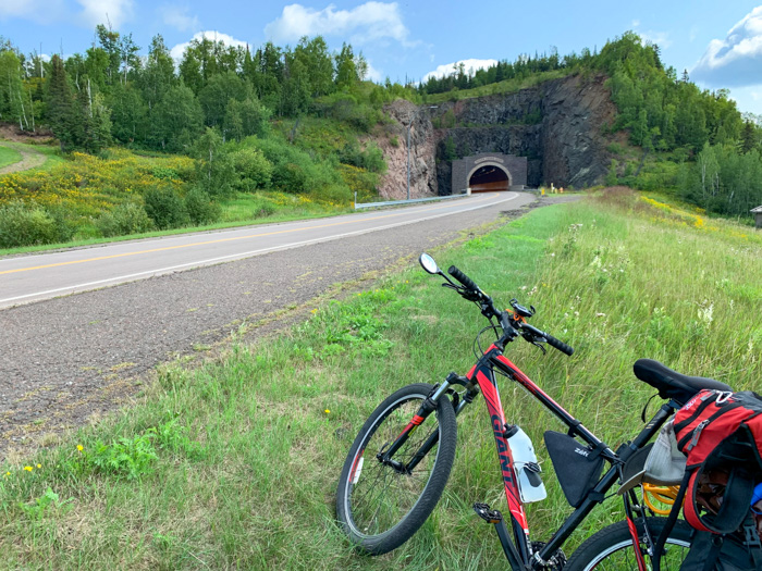 Highway 61 Tunnel A bicycle on the side of a road in front of a tunnel