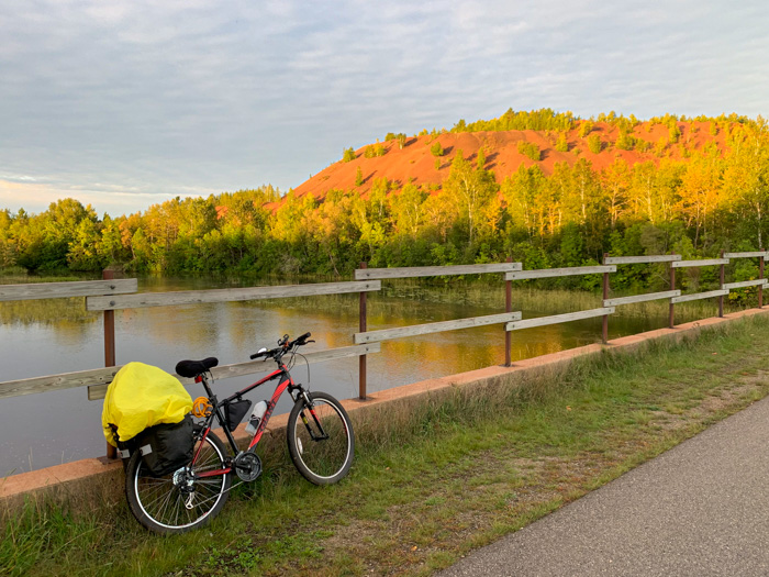 Mesabi Trail Morning A bicycle leans against a fence by a lake just off a bike trail