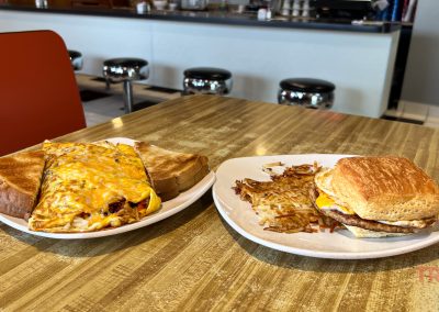 A closeup of two plates of breakfast food on a counter