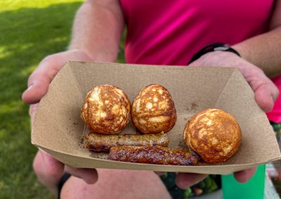 A closeup of a serving of Ableskiver with sausage