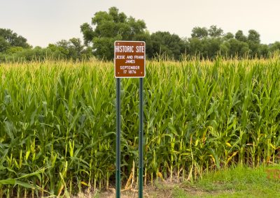 A brown marker near a corn field mentions Jesse and Frank James and the date September 17, 1876