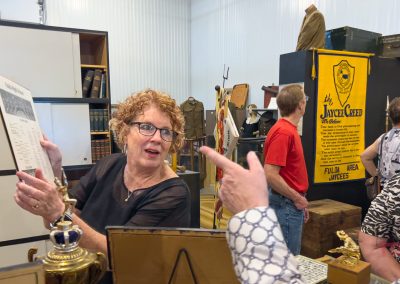 Two women examine an old record album in a museum