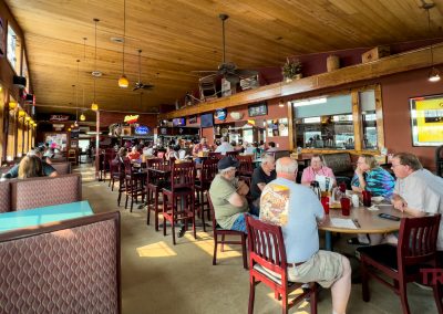 The interior of a family-style restaurant with a wood ceiling