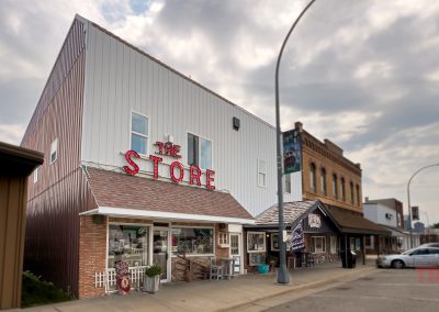 The Store in Fulda MN is a two story, gray metal clad building with brick accents