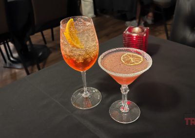Two fancy drinks on a table in a resaturant