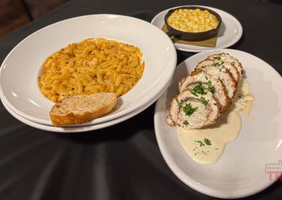 Closeup of plates of fine dining foods on a restaurant table