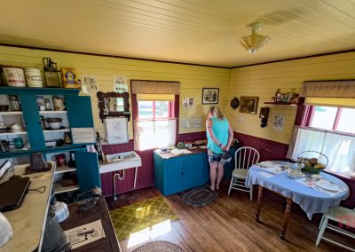 A woman studies an old recipe card in a historic cabin