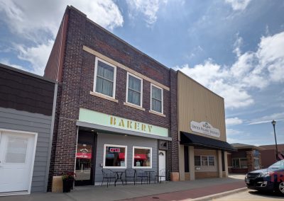 The two-story brown brick and wood exterior of a bakery