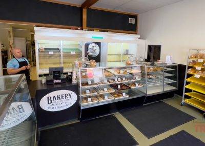 Pastries and breads in cases and racks inside of a bakery