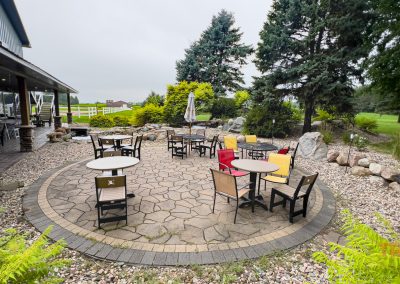 A stone patio outside of a winery tasting room