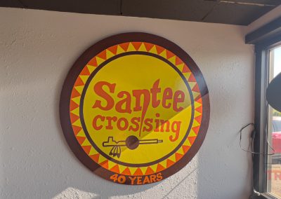 A round sign on a wall reads "Santee Crossing 40 years"