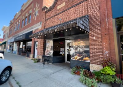 The one-story red brick exterior of a coffee shop