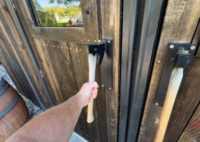 Axes turned door handles on a heavy wooden door