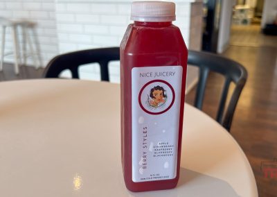 A closeup of a bottle of red juice