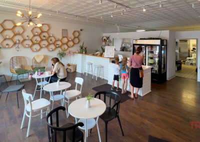 The interior of a juice bar with white walls and modern decor
