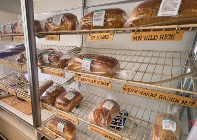 A display case filled with loaves of bread