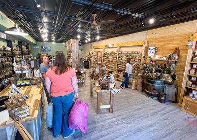 Patrons browse a spice shop lined with jars on shelves