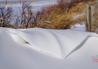 A closeup of a snow drift resembling a folded piece of cloth