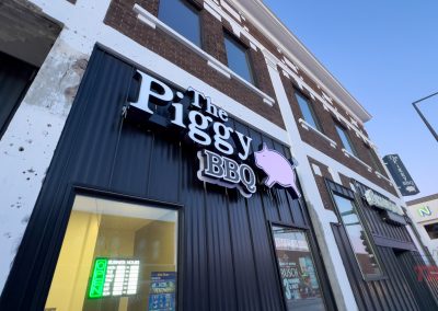 The black metal and brown brick exterior of The Piggy BBQ